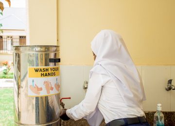 A student washing her hands before eating food