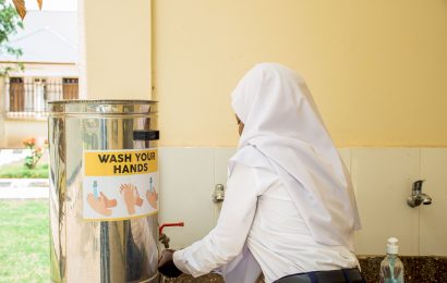 A student washing her hands before eating food