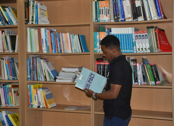 Student Picking a Book to Borrow for a Good Read